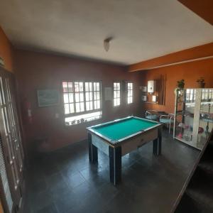 a living room with a pool table in it at Pousada Miramar in Marataizes
