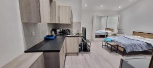 a kitchen with a counter and a bed in a room at Ilford Towncentre Large Studio in Ilford