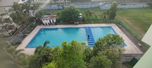 an overhead view of a large blue swimming pool at EL MEIR STAYCATION SMART CABIN BESIDE ENCHANTED KINGDOM in Santa Rosa