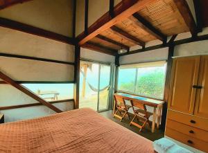 a bedroom with a bed and a desk with a window at Casa Las Mantas in Santa Marianita