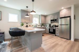 a kitchen with stainless steel appliances and wooden floors at Epic House in Atwater Village in Glendale