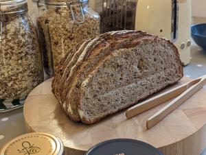 a loaf of bread sitting on a cutting board at Sidney Grove B&B in Newcastle upon Tyne +40 photos