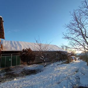a house with snow on the ground in front of it at Khachik White Canyon in Khachʼik
