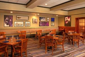 a dining room with wooden tables and chairs at Sheraton Bucks County Langhorne in Langhorne