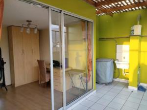 a room with a glass closet with a desk in it at Tait's House - Cómodo departamento Dúplex - Ate in Lima +18 photos