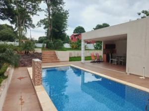 a swimming pool in front of a house at La Piña Dorada in San Lorenzo de la Frontera