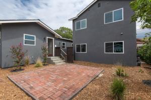 a gray house with a brick driveway at Beautiful Apartment in Atwater Village in Glendale