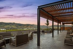 a patio with tables and chairs and a view of mountains at Courtyard by Marriott Pocatello in Pocatello