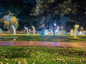 a park at night with lights in the grass at Hermoso y Familiar Apartamento Cedritos in Bogotá