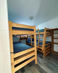 a bedroom with two bunk beds in a room at Complejo bosque escondido in Quillón