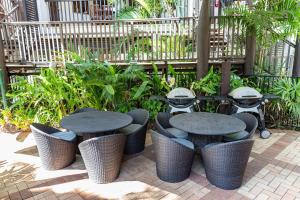 a group of tables and chairs in a courtyard at Hibiscus Resort & Spa - Official Onsite Reception & Check In in Port Douglas