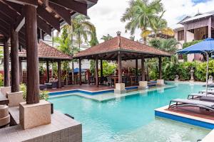 a swimming pool with a gazebo and a resort at Hibiscus Resort & Spa - Official Onsite Reception & Check In in Port Douglas