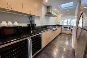 a large kitchen with a black counter top at Private Beautiful Eastside Townhome near UN in New York