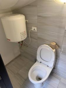 a bathroom with a toilet with a water tank at Студії біля Радіозаводу in Ivano-Frankivsʼk