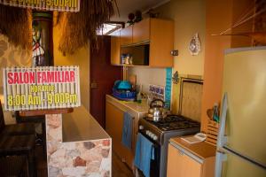 uma pequena cozinha com um fogão e um frigorífico em Hotel Sunset Chancay em Chancay
