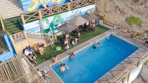 an overhead view of people in a swimming pool at Hotel Sunset Chancay in Chancay