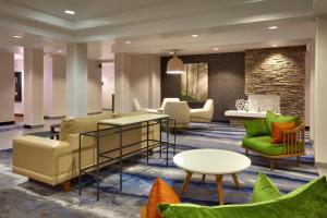 a lobby with couches and tables and chairs at Fairfield Inn & Suites Roswell in Roswell