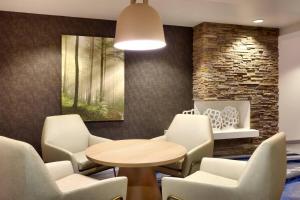 a waiting room with a table and chairs at Fairfield by Marriott Inn & Suites Roswell in Roswell +24 photos