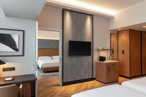 a hotel room with a sliding door with a television at Sheraton Mall of the Emirates Hotel, Dubai in Dubai