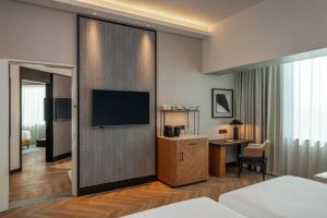 a hotel room with a television and a desk at Sheraton Mall of the Emirates Hotel, Dubai in Dubai