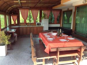 a dining room with a table and a kitchen at Villa Olymp in Golden Sands