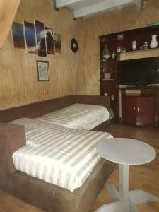 a small bedroom with a bed and a table at Apartamento interior in Coihaique