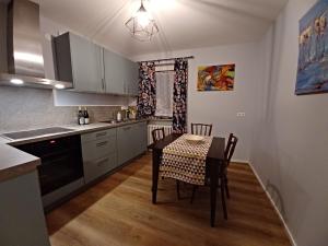a kitchen with a table and a dining room at Weinberg-Ferienwohnung, Oberrotweil in Oberrotweil