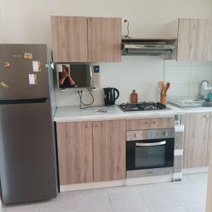 a kitchen with a refrigerator and a stove at Amplio y comodo departamento in La Serena