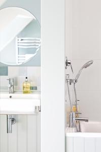 a bathroom with a sink and a mirror at The Apartments @ Quidhampton Mill in Salisbury +20 photos