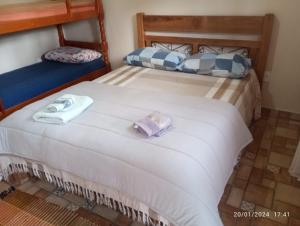 a bedroom with a bed with two towels on it at Pousada Santa Bárbara in Tiradentes