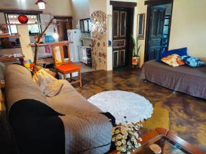 a living room with a couch and a table at Casa Paradise - charmechapad a in Alto Paraíso de Goiás +65 photos
