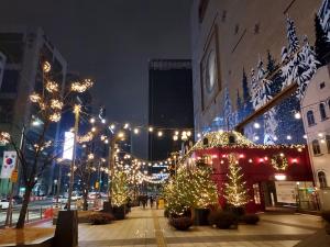 a city street decorated with christmas lights and trees at Coex Stay in Seoul