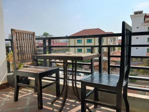 a table and two chairs on a balcony at Andy's Place in Siem Reap