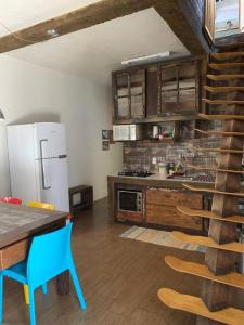 a kitchen with a refrigerator and a table and chairs at Casa em Torres/RS in Torres