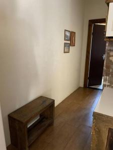 a room with a wooden table in the corner of a room at Casa em Torres/RS in Torres