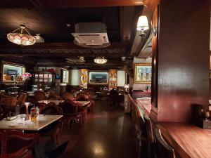 a restaurant with people sitting at tables in a room at Coex Stay in Seoul