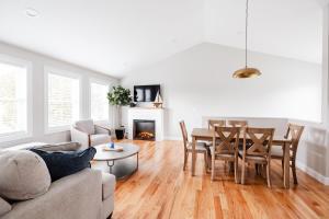 a living room with a couch and a table and chairs at Rest in Westerly in Westerly