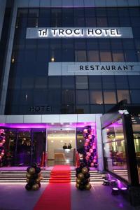 a hotel with a red carpet in front of a building at Troci Hotel in Tirana