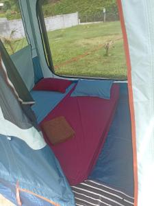 an open tent with the door open and a window at Camping TENUI in Taputapuapea