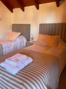 two beds sitting next to each other in a bedroom at Casa Estivariz Madryn in Puerto Madryn +73 photos