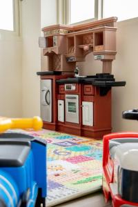 a toy kitchen with a toy truck on the floor at Boss's home in Dongshan