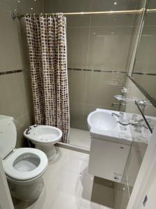 a bathroom with a toilet and a sink and a shower at Soldemonte in Monte Hermoso