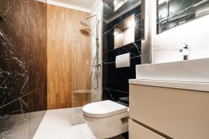 a bathroom with a toilet and a sink and a shower at Golden Crown Apartments by In Property in Sveti Stefan