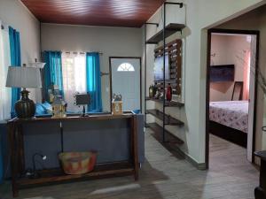a bedroom with a bed and a desk with a mirror at La Casita del Lago en El Jaral in Santa Cruz de Yojoa