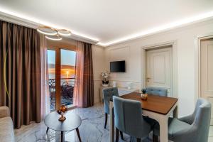 a living room with a table and chairs and a dining room at Golden Crown Apartments by In Property in Sveti Stefan