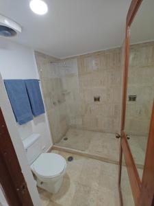 a bathroom with a toilet and a shower at Hotel Plaza Huatulco Bungalows in Santa Maria Huatulco