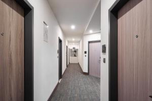 a corridor of a hospital hallway with a row of doors at Yung An Business Hotel in Dounan