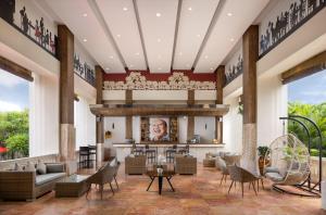 a lobby with couches and chairs and a bar at Tonys Villas & Resort Seminyak - Bali in Seminyak