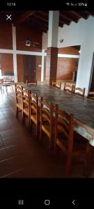 a large table and chairs in a room with a table at la soñadita in Salta