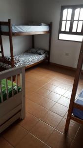 a room with two bunk beds and a tile floor at la soñadita in Salta